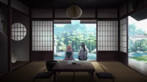 Alto and Sheryl sitting in Japanese room with doors slid open to pond garden